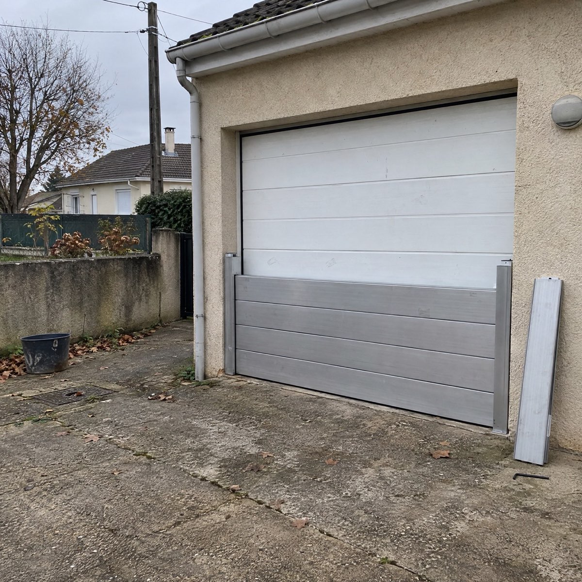 Batardeau aluminium posé devant une porte de garage